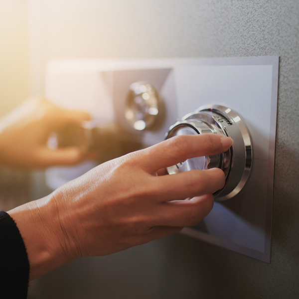 hands using dial to unlock safe